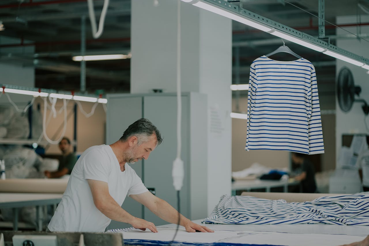Man Working with Textile in Workshop
